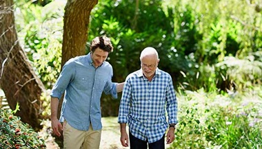 Two men walking together in nature. 