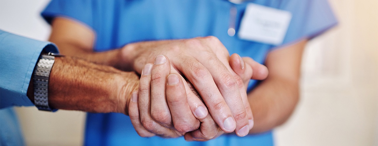 nurse holding patient hand