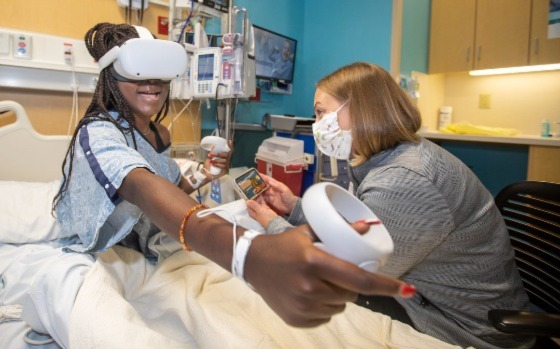 Abihannah using a virtual reality system for pain management at John Hopkins All Children's Hospital. 