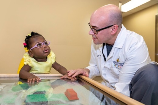 Sarah with pediatric surgeon C. Jason Smithers, M.D., at Johns Hopkins All Children's