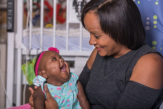 Bella looks at her mother with joy in All Children's neonatal intensive care unit