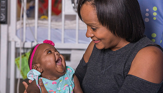 Bella looks at her mother with joy in All Children's neonatal intensive care unit