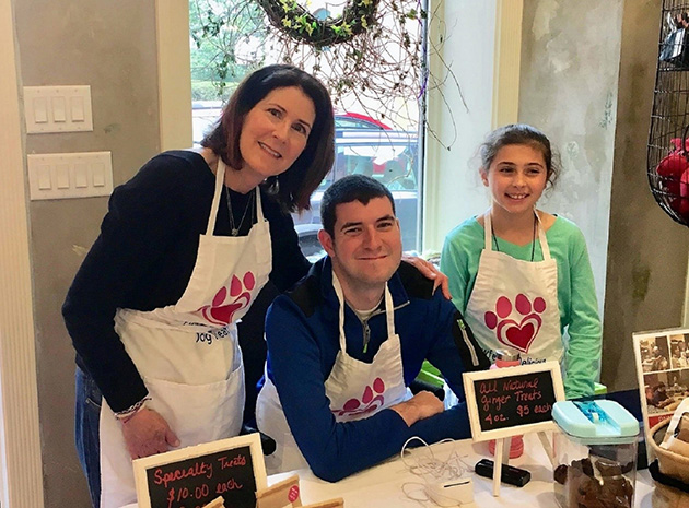 Bryan and his family working at their dog treat bakery