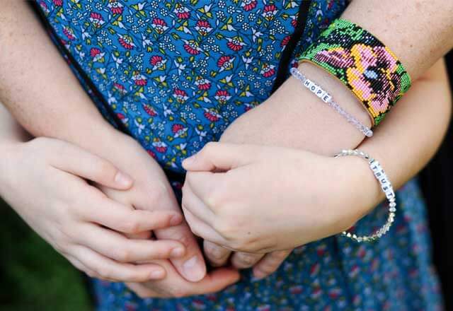 Danica and her mom wear matching bracelets symbolizing hope and trust