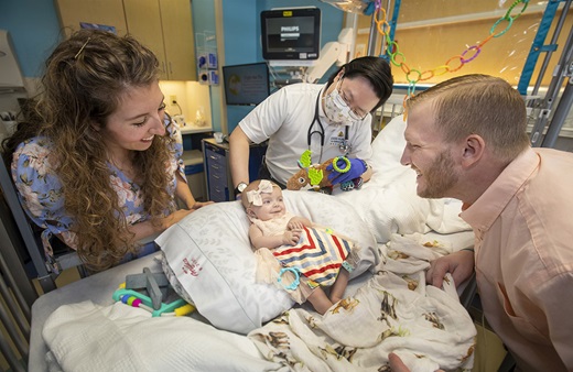 Baby Evelyn, her parents, and Dr. Kim at John Hopkins All Children's Hospital. 
