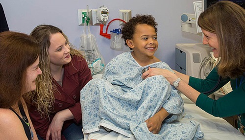 Young boy being examined by John Hopkins All Children's Hospital staff.