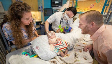 Baby Evelyn, her parents, and Dr. Kim at John Hopkins All Children's Hospital. 