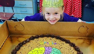 Gracie celebrating at her kindergarten with her cookie cake