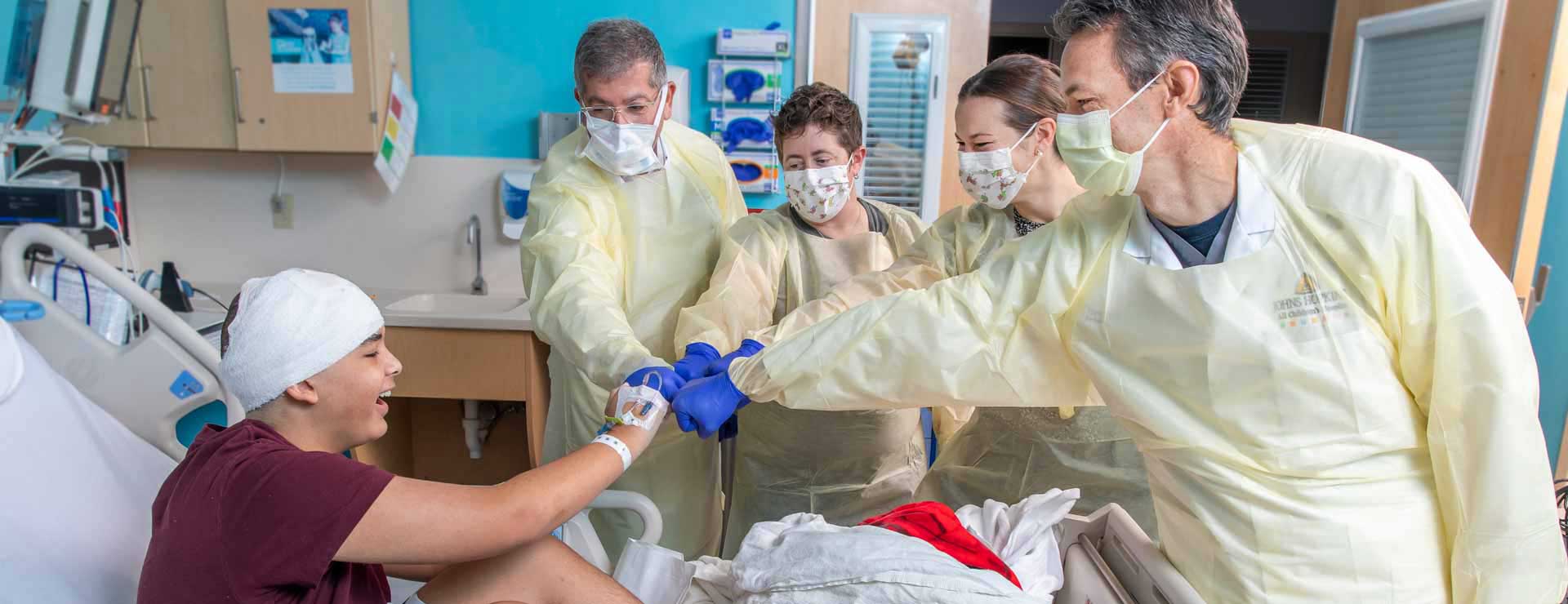 Jaden bumping fists with his surgical team