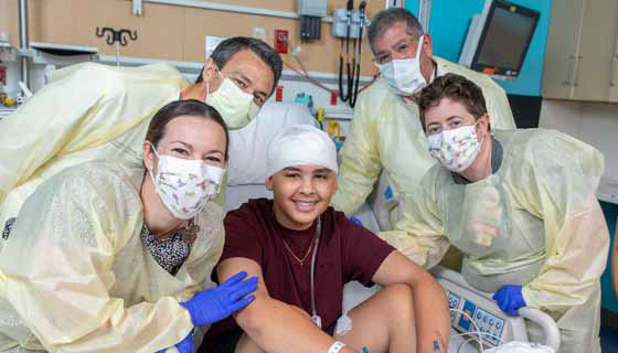 A photo of patient Jaden with his care team at Johns Hopkins All Children's Hospital