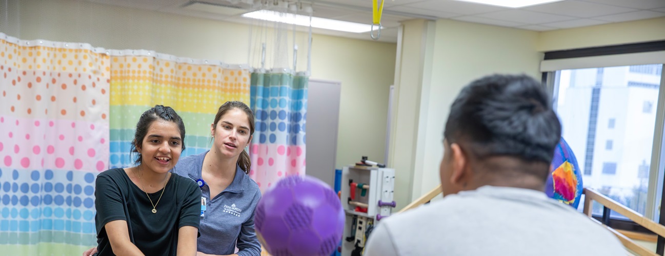 Jasmin at a recent physical therapy session with her brother Cruz and physical therapy assistant Nicole Visokay at Johns Hopkins All Children's Hospital