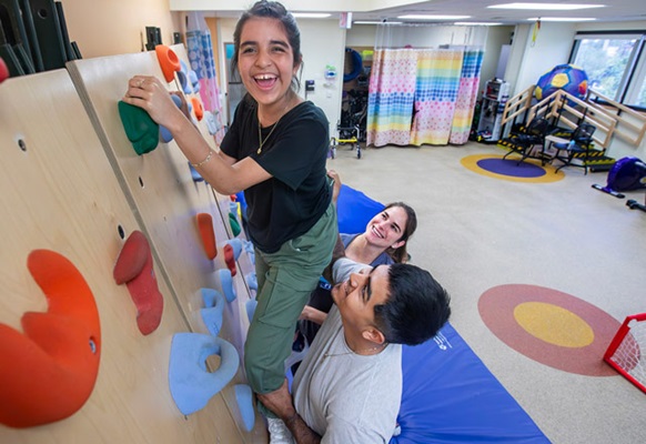 Jasmin at a recent physical therapy session with her brother Cruz and physical therapy assistant Nicole Visokay at Johns Hopkins All Children's Hospital