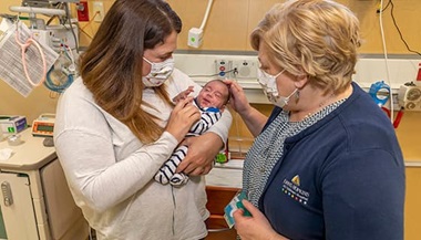 John-Derrick and his mother Anna with nurse practitioner Carolyn Kelly, APRN. The family and Kelly formed a special bond after learning they were all from the same town in Newfoundland, in Canada.