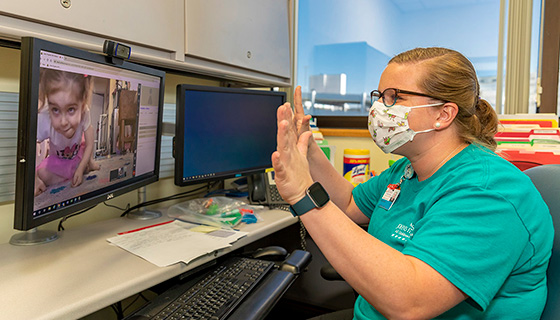 Occupational therapist Breanna Howell works with Lily during a telemedicine appointment.