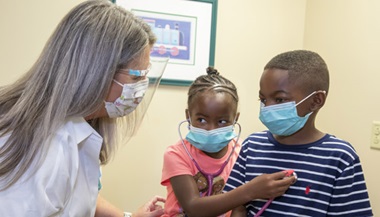 Marcus and his sister Emma learn about sickle cell from Carrie Gann, D.N.P.