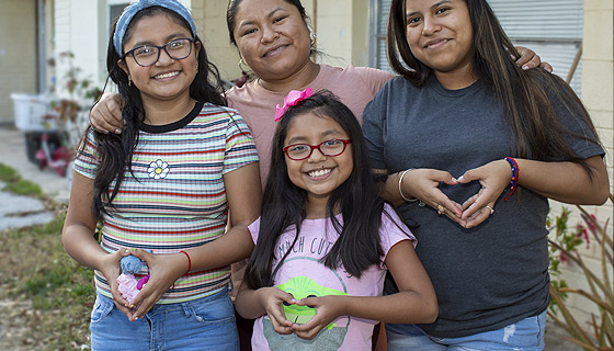 Michelle and her family with the model of her heart her surgeon used to aid in planning her surgery.