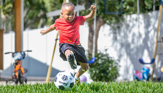 Erik playing soccer in his yard