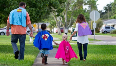 Sofia and her family in their super hero capes