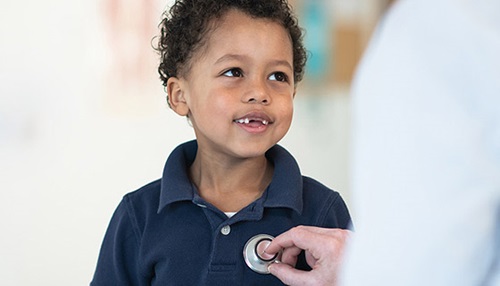 A boy having his heart checked with a stethoscope at All Children's Hospital