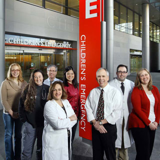 At their new entrance, Pediatric ED physicians Elizabeth Hines, Karen Schneider, Bruce Klein, Jean Ogborn, Thuy Ngo, Doug Baker, Mitchell Goldstein, and Jennifer Anders.