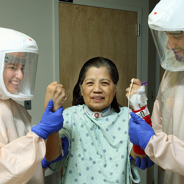 April Pruski, a physiatrist, on left, and Bhavesh Patel, a resident physiatrist, on right, assess a patient’s strength.
