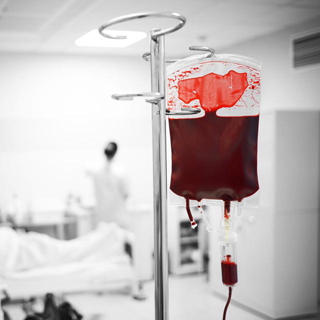 Photo of a blood transplant bag hanging in an operating room.
