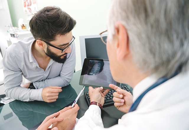 Man and doctor look at x-rays