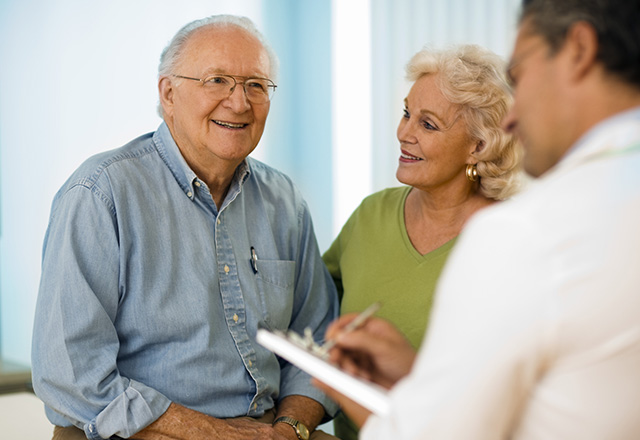 Man talks with health professionals