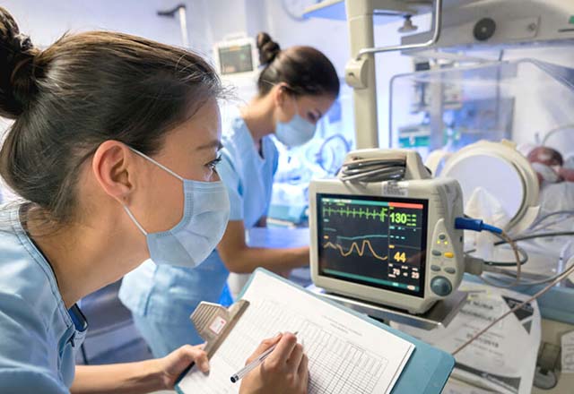 NICU nurses look at monitors