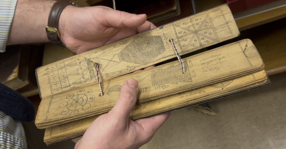 A photo of rare manuscripts with black text