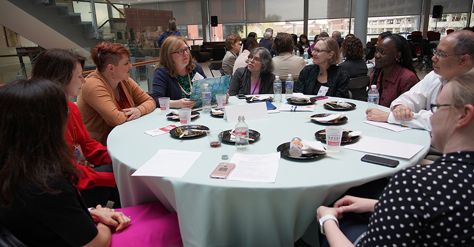 attendees chat over lunch during conference