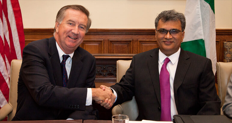 Shaking hands after signing agreement with Nigeria's Me Cure