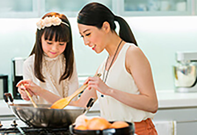 mother and daughter cooking