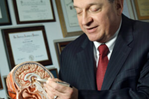 Dr Alan Cohen with a brain