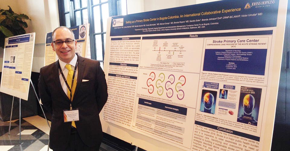 Doctor standing in front of a research poster.