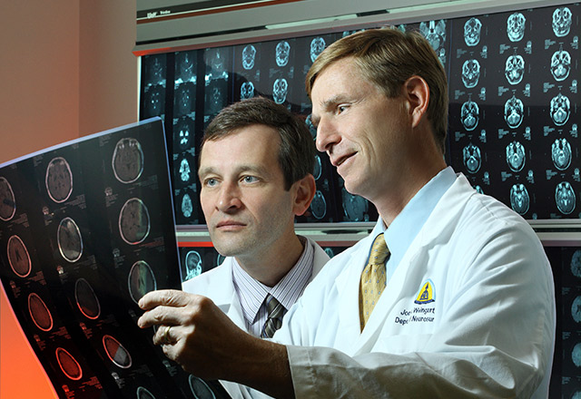 Dr. Jon Weingart examining brain scans