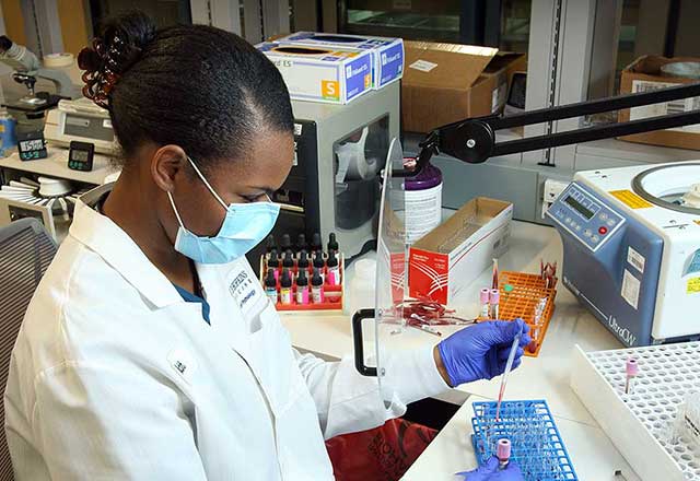 Provider testing a blood sample in a lab.