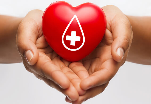 Cupped hands holding a heart with droplet icon on it.