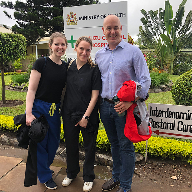 Eric McCollum with physicians Brittany Hunter, left, and Chiara Bertolaso at Kamuzu Central Hospital