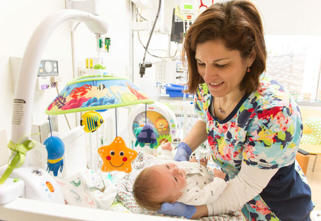 Neonatal-Perinatal Medicine nurse with baby