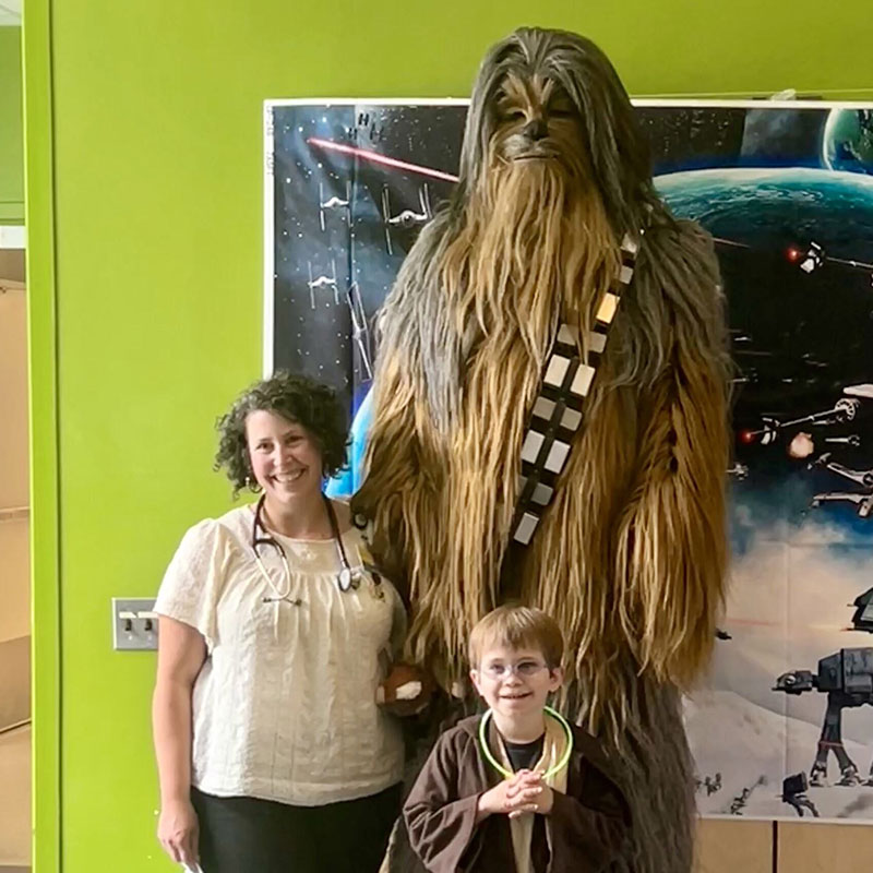 Dr. Julia Shalan with a child at Johns Hopkins event.