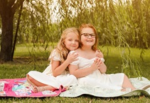 Elle and Emme on a picnic blanket