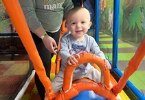 Ryland playing on an infant jungle gym