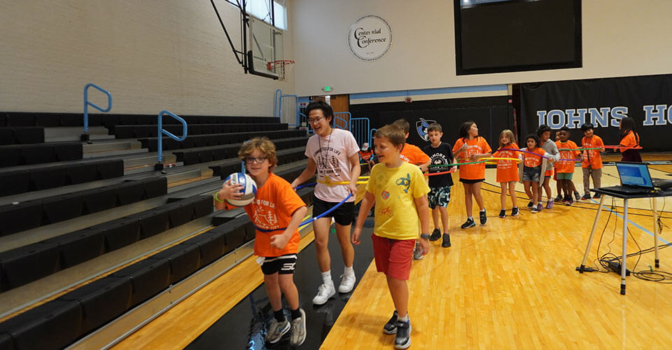 kids playing with hula hoops and dodgeball