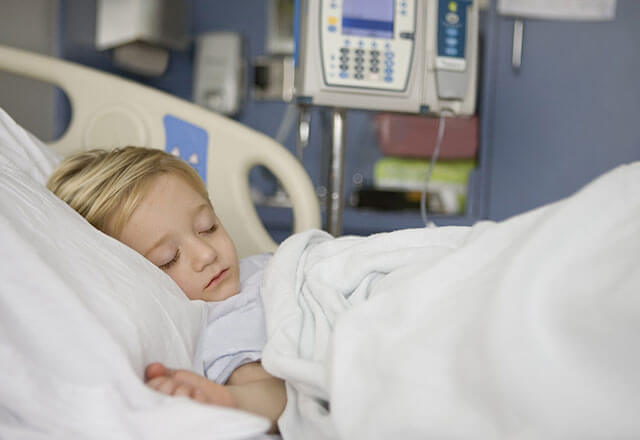child sleeping in a hospital bed