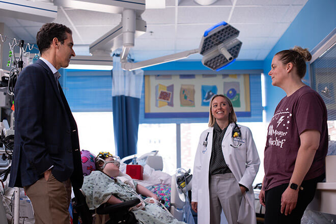 Aaron Milstone and Anna Sick-Samuels meet with a mother and young patient