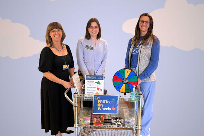 Project PROTect members with the Protect on Wheels cart