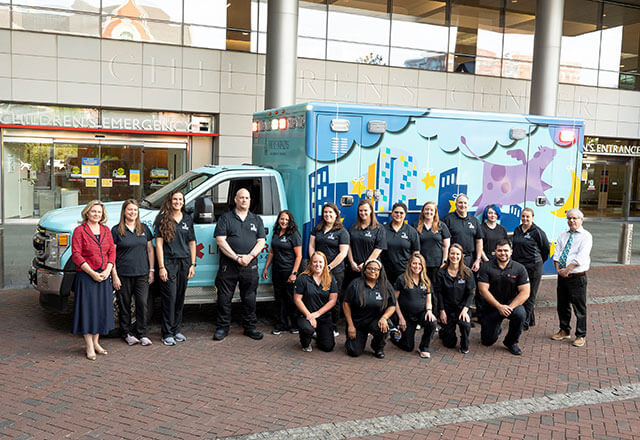 Pediatric Transport team in front of an ambulance 