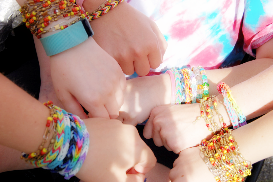 Camp Sunrise hands with many bracelets
