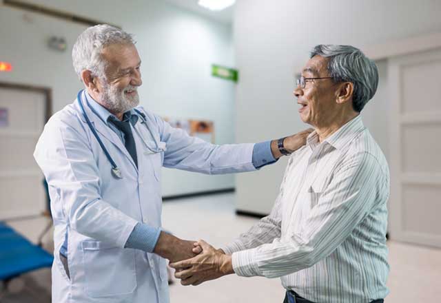 Doctor shaking hands with a male patient